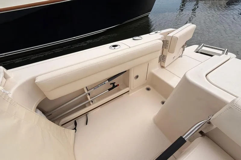 Slide: The Image of 2025 Grady-White Freedom 235 boat interior with seating and storage features. - 12