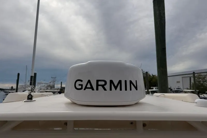 Slide: The Image of Garmin radar on 2025 Grady-White Freedom 235 boat, docked under cloudy sky. - 15