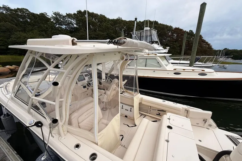 Slide: The Image of 2025 Grady-White Freedom 235 boat docked, featuring sleek design and spacious interior. - 3