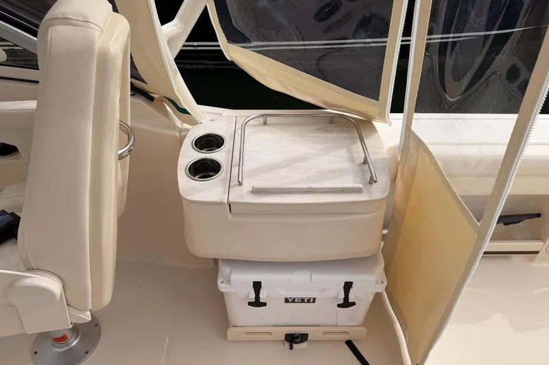 Slide: The Image of 2025 Grady-White Freedom 235 boat interior with seating and Yeti cooler. - 9