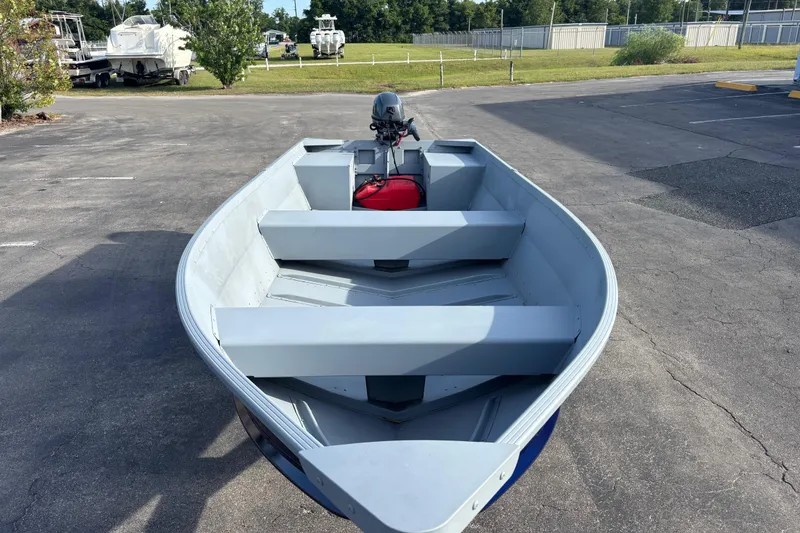 Slide: The Image of 2025 G3 Guide V16 XT boat in parking lot, featuring outboard motor. - 10