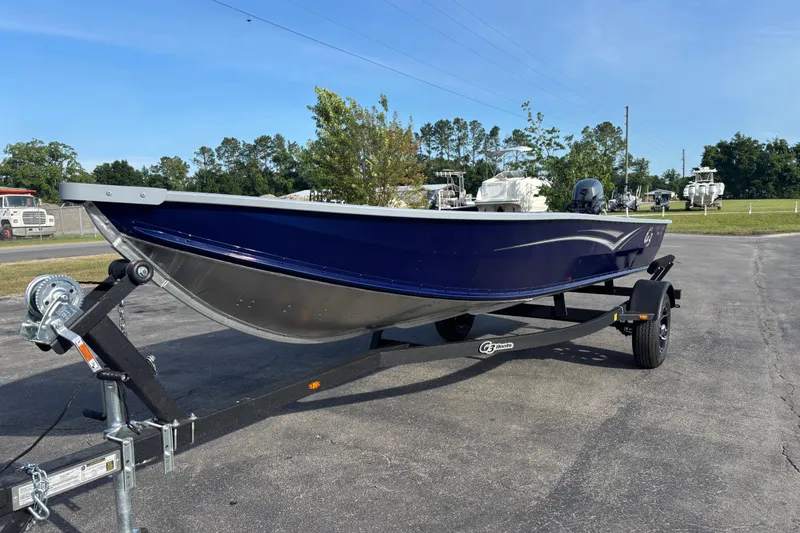 Slide: The Image of 2025 G3 Guide V16 XT boat on trailer, parked outdoors under clear sky. - 4