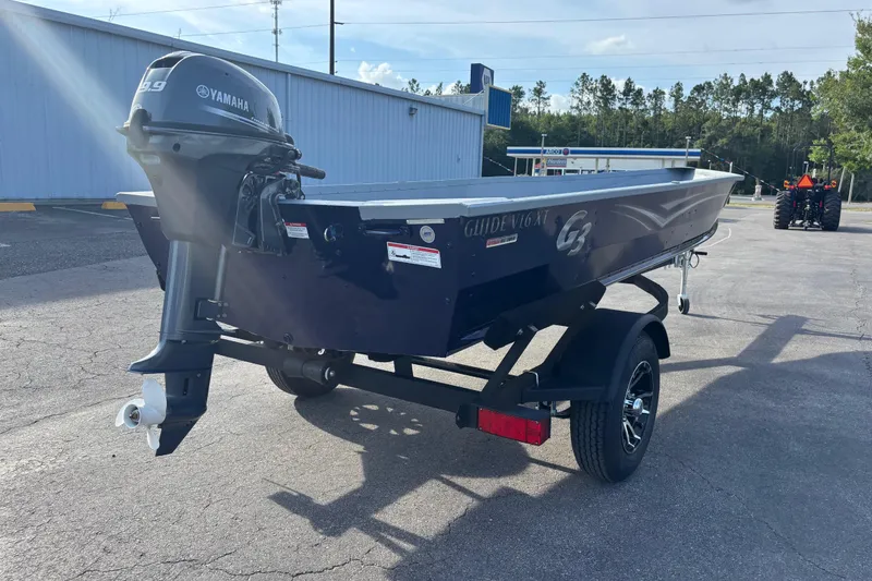 Slide: The Image of 2025 G3 Guide V16 XT boat with Yamaha motor on trailer in parking lot. - 9