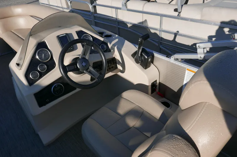 Slide: The Image of 2018 Sweetwater SW2086c boat interior with steering wheel and control panel. - 11