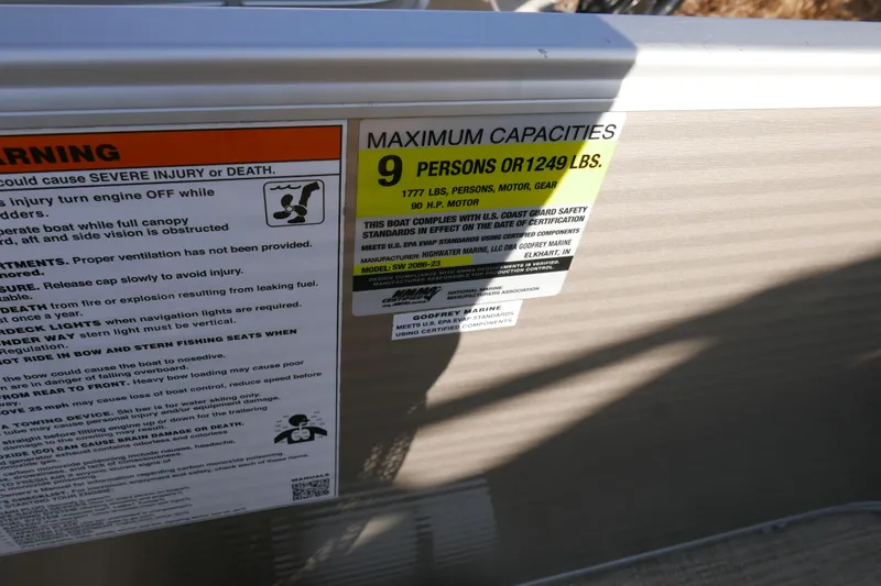 Slide: The Image of Warning and capacity labels on 2018 Sweetwater SW2086c boat, maximum 9 persons or 1249 lbs. - 14