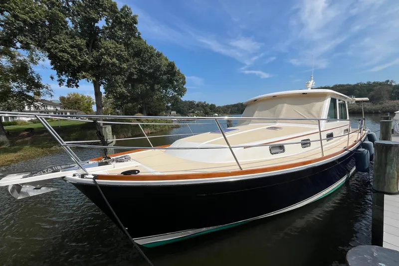 Slide: The Image of 2012 Sabre 42 Salon Express yacht docked by a scenic waterfront. - 30