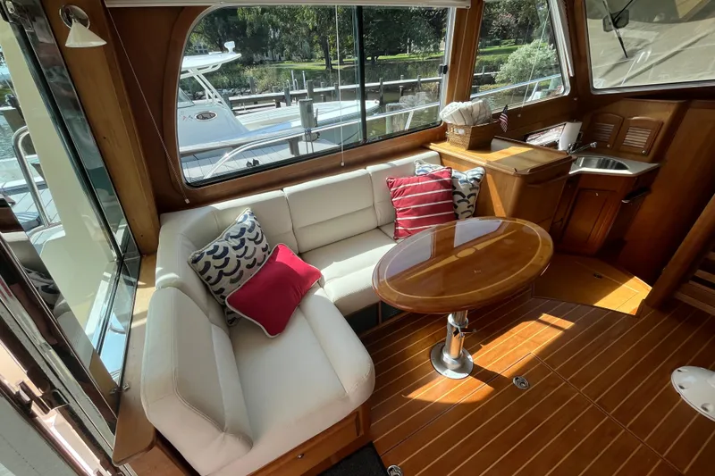 Slide: The Image of Interior of 2012 Sabre 42 Salon Express with cozy seating and wooden table. - 6