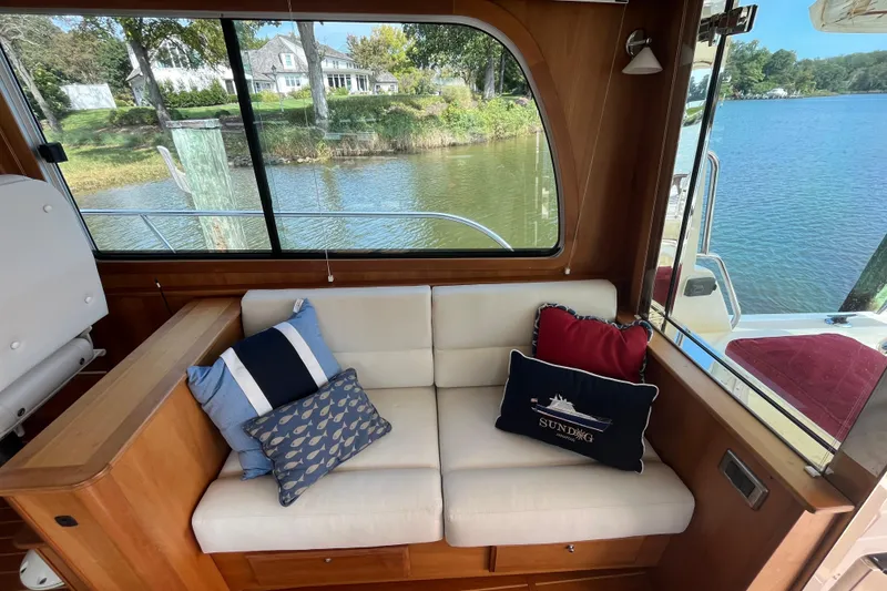 Slide: The Image of Interior of 2012 Sabre 42 Salon Express with cozy seating and decorative pillows. - 7