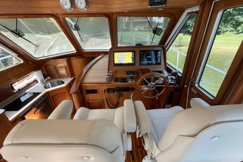 Slide: The Image of Interior of 2012 Sabre 42 Salon Express yacht with helm, navigation screens, and kitchenette. - 8