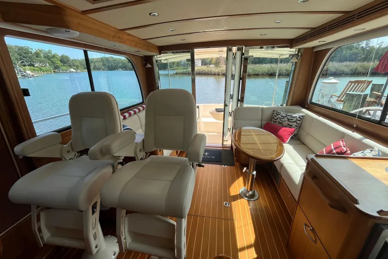 Slide: The Image of Interior of 2012 Sabre 42 Salon Express yacht with plush seating and scenic water view. - 9