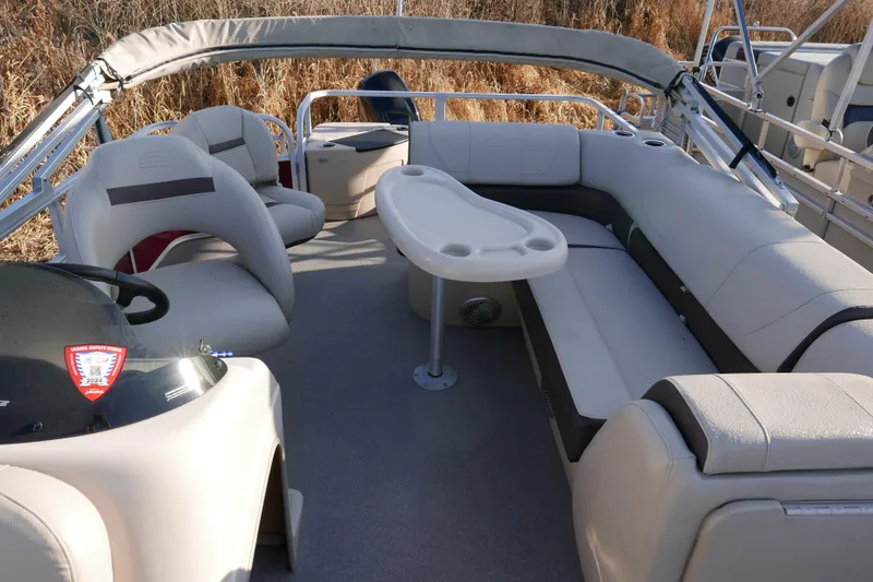 Slide: The Image of 2018 SUNTRACKER Fish N Barge 20 pontoon boat interior with seating and table. - 7