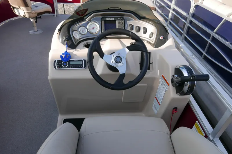 Slide: The Image of 2018 SUNTRACKER Fish N Barge 20 boat dashboard with steering wheel and controls. - 9