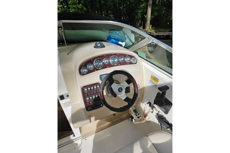 Slide: The Image of 2002 Chaparral Signature 240 boat dashboard with steering wheel and control panel. - 4