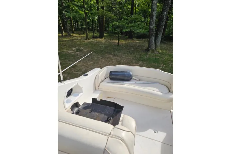 Slide: The Image of 2002 Chaparral Signature 240 boat interior with seating and wooded background. - 6