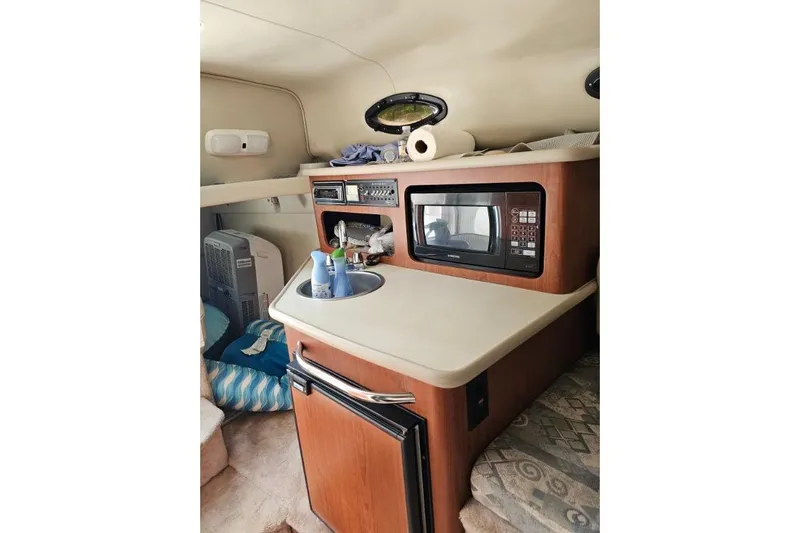 Slide: The Image of 2002 Chaparral Signature 240 cabin interior with kitchenette, microwave, and sink. - 8