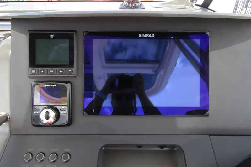 Slide: The Image of 2024 Nimbus T8 dashboard with Simrad and Zipwake displays. - 17