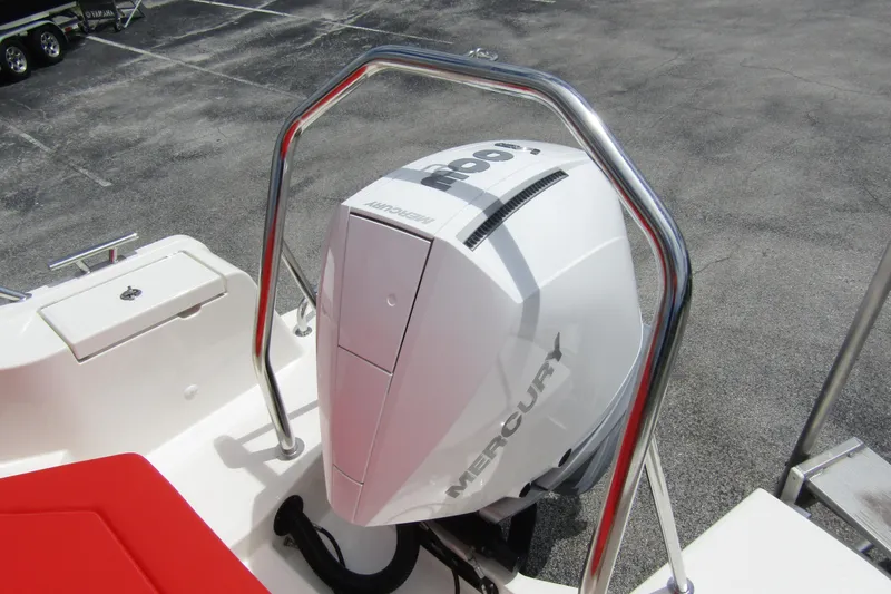 Slide: The Image of 2024 Nimbus T8 boat with Mercury outboard engine, red seating, and stainless steel railing. - 30