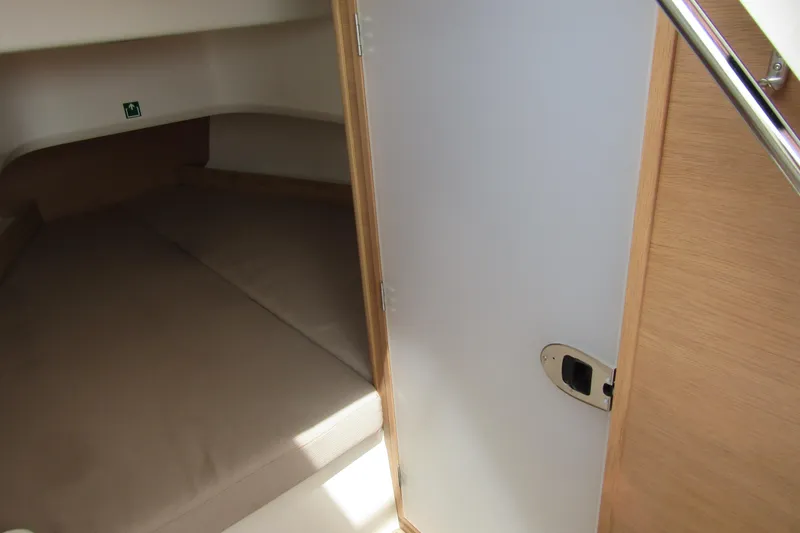 Slide: The Image of 2024 Nimbus T8 cabin interior with wooden door and cozy sleeping area. - 22