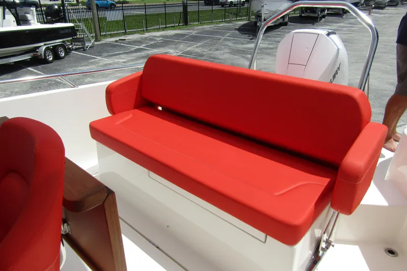 Slide: The Image of Red cushioned seating on 2024 Nimbus T8 boat, featuring sleek design and modern comfort. - 26