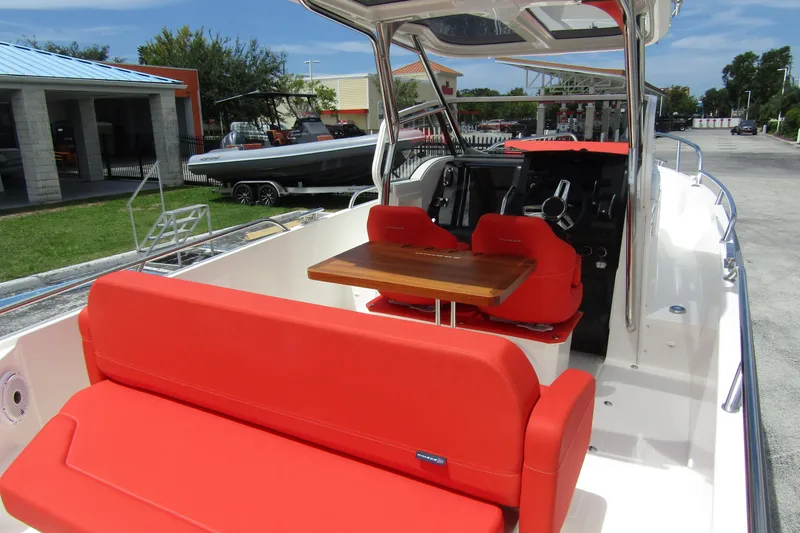 Slide: The Image of 2024 Nimbus T8 boat with vibrant red seating and sleek interior design. - 35