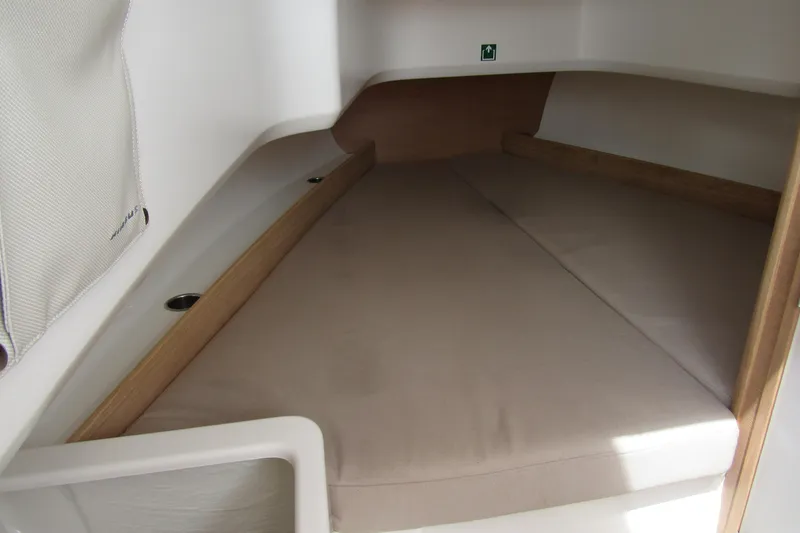 Slide: The Image of 2024 Nimbus T8 cabin interior with beige cushions and wooden accents. - 21