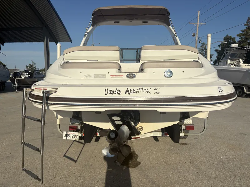 Slide: The Image of 2013 Rinker Captiva 276 boat with beige seating, parked outdoors. - 10
