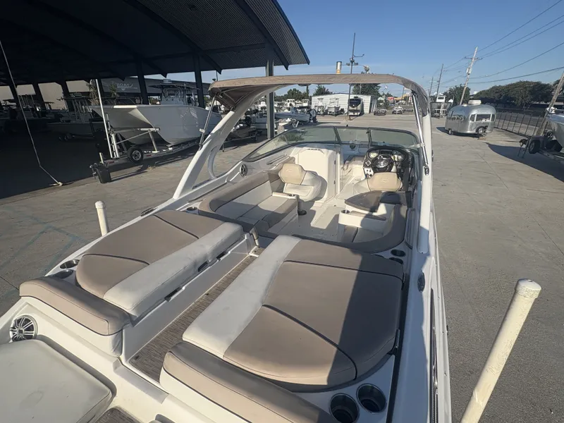 Slide: The Image of 2013 Rinker Captiva 276 boat interior with beige seating and steering console. - 11