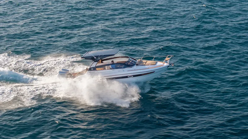 Slide: The Image of 2025 Hanover 305 boat cruising on open sea waters. - 13