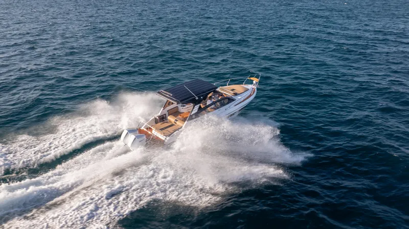 Slide: The Image of Hanover 305 boat cruising on open water, 2025 model, aerial view. - 14