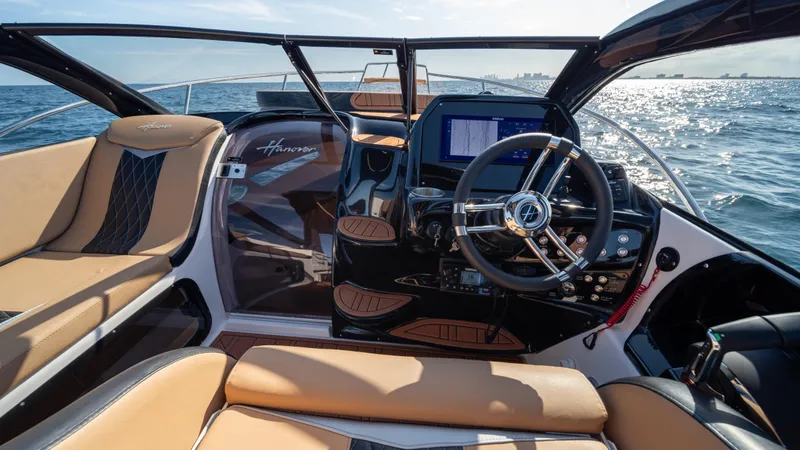 Slide: The Image of Luxurious 2025 Hanover 305 boat interior with modern steering and seating on open water. - 17