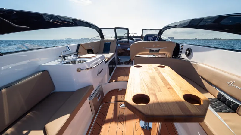 Slide: The Image of Luxurious 2025 Hanover 305 boat interior with wooden table and seating, cruising on open water. - 19