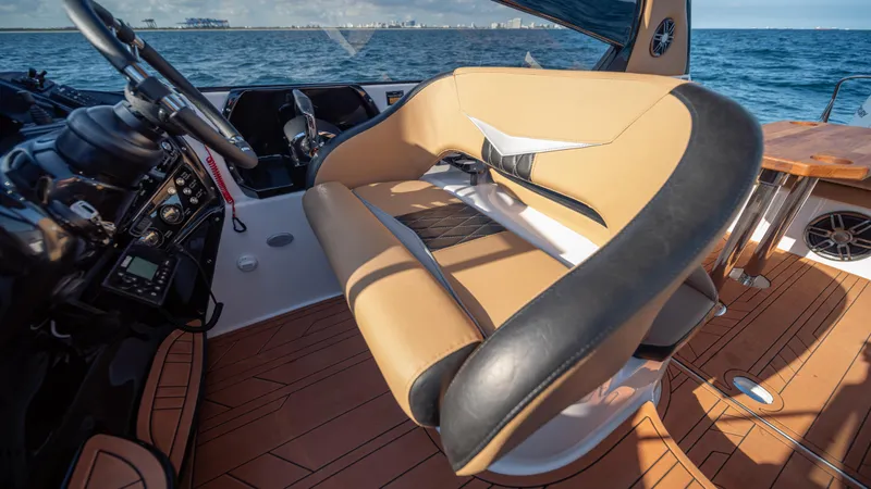Slide: The Image of Luxurious interior of 2025 Hanover 305 boat with tan seating and ocean view. - 25