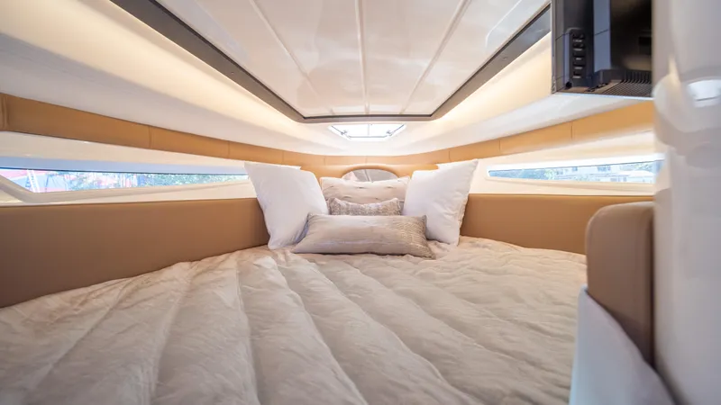 Slide: The Image of Luxurious interior cabin of 2025 Hanover 305 yacht with plush bedding. - 30