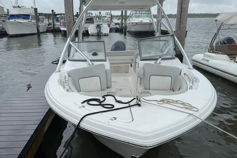 Slide: The Image of 2022 Seafox 226 Traveler boat docked at marina with open seating area. - 2