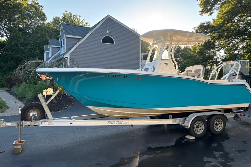 The Image of 2018 Tidewater 232 LXF boat on trailer, parked in driveway near house. - 1