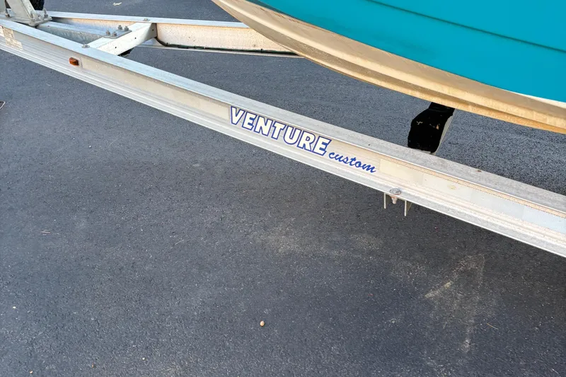 Slide: The Image of Trailer for 2018 Tidewater 232 LXF boat on asphalt surface. - 11