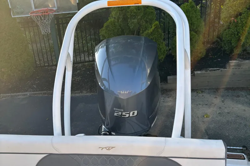 Slide: The Image of 2018 Tidewater 232 LXF boat with Yamaha 250 engine, parked near basketball hoop. - 12