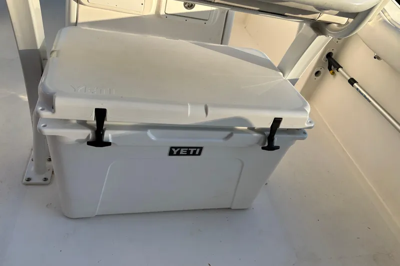 Slide: The Image of White YETI cooler on 2018 Tidewater 232 LXF boat deck. - 19