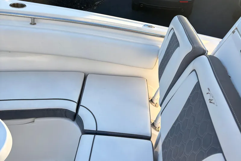 Slide: The Image of 2018 Tidewater 232 LXF boat interior seating with white and gray upholstery. - 25