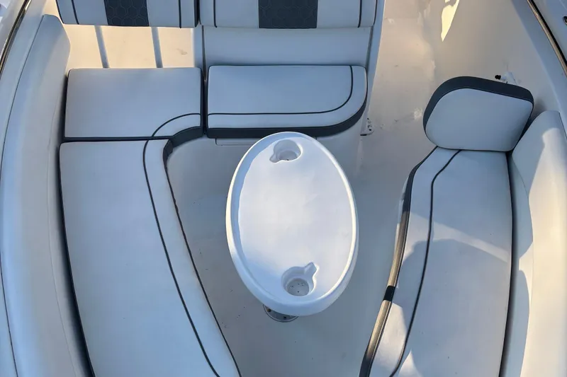 Slide: The Image of 2018 Tidewater 232 LXF boat interior with white seating and oval table. - 27