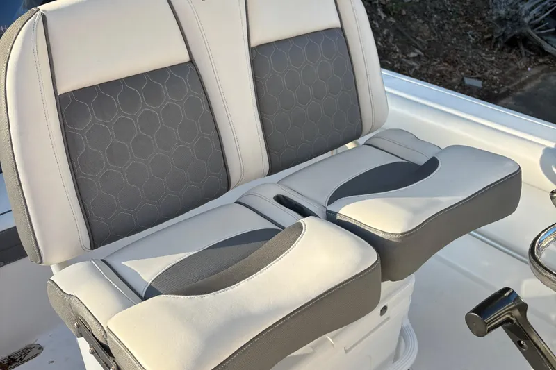Slide: The Image of 2018 Tidewater 232 LXF boat seats with gray and white upholstery, hexagonal pattern design. - 7