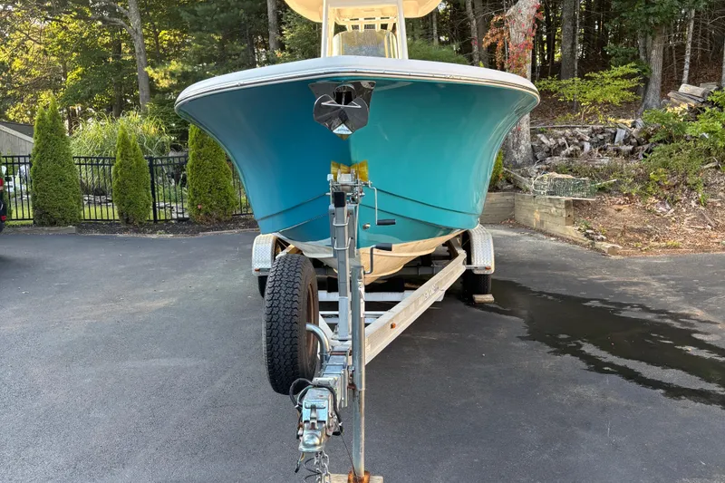 Slide: The Image of 2018 Tidewater 232 LXF boat on trailer, parked in a wooded driveway. - 8