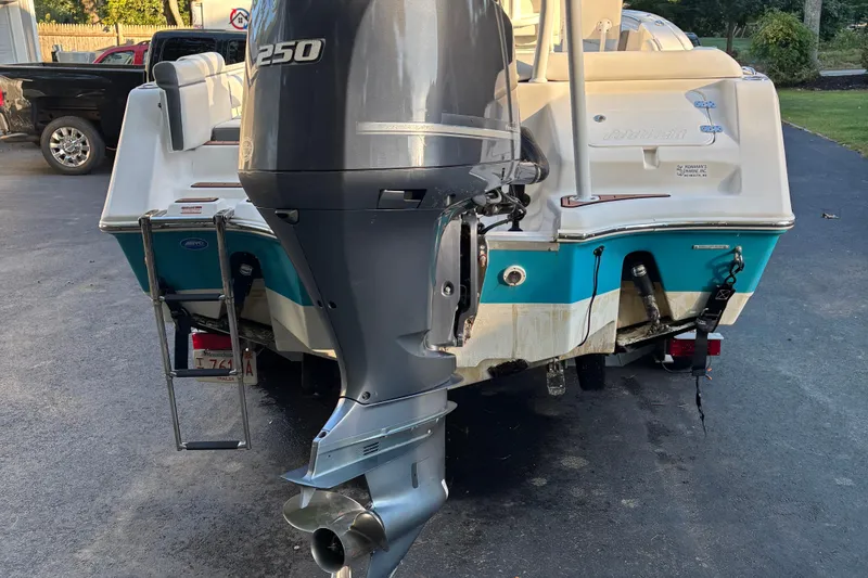 Slide: The Image of 2018 Tidewater 232 LXF boat with powerful outboard motor, parked on driveway. - 9