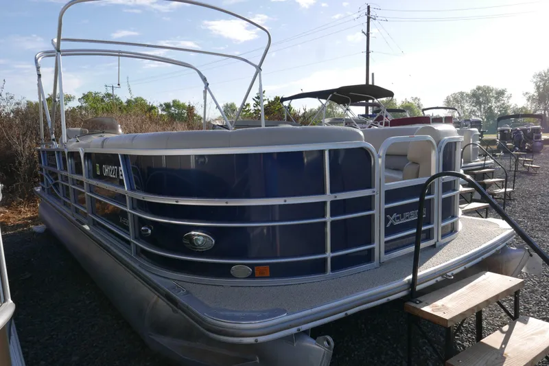 Slide: The Image of 2012 Xcusrion x2312 pontoon boat with blue exterior, parked outdoors. - 1