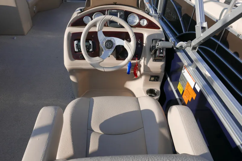Slide: The Image of Interior of a 2012 Xcusrion x2312 boat showing steering wheel and dashboard controls. - 10