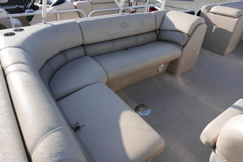 Slide: The Image of 2012 Xcusrion x2312 boat interior with beige seating and cup holders. - 11