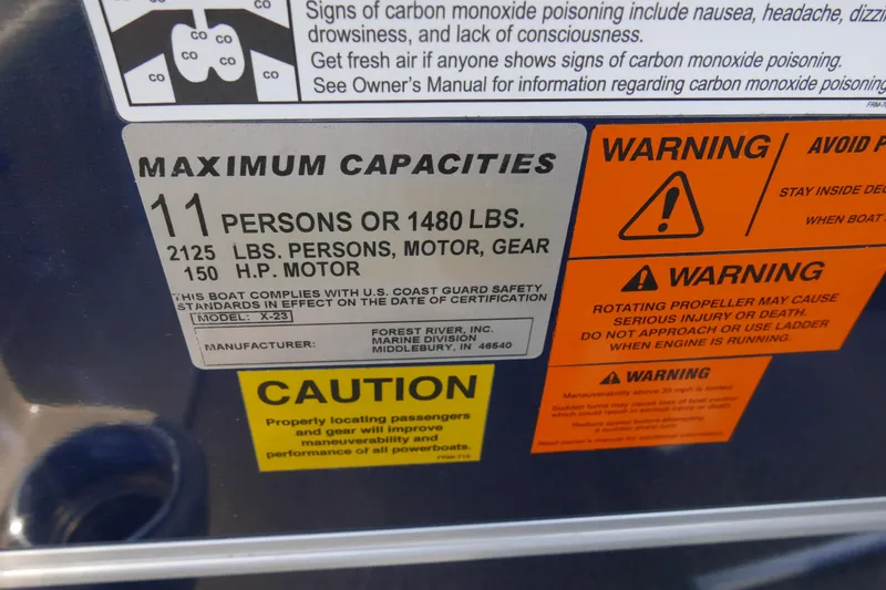 Slide: The Image of Boat capacity warning label for Xcursion X2312, 2012 model, detailing safety and weight limits. - 13