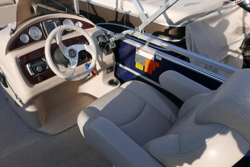 Slide: The Image of Steering console of 2012 Xcusrion x2312 boat with beige seating and control panel. - 9