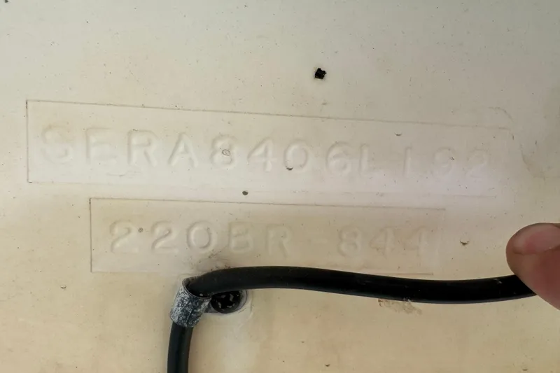 Slide: The Image of 1991 Sea Ray 220 boat hull identification number with visible cable. - 10