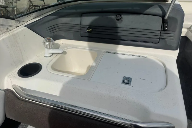Slide: The Image of 1991 Sea Ray 220 boat interior with sink and storage compartment. - 11